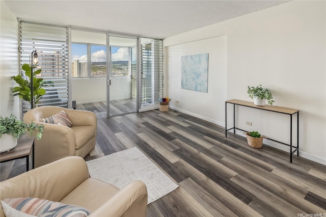 1031 Ala Napunani St Unit 1002, Honolulu, HI 96818 - living room featuring baseboards and wood finished floors