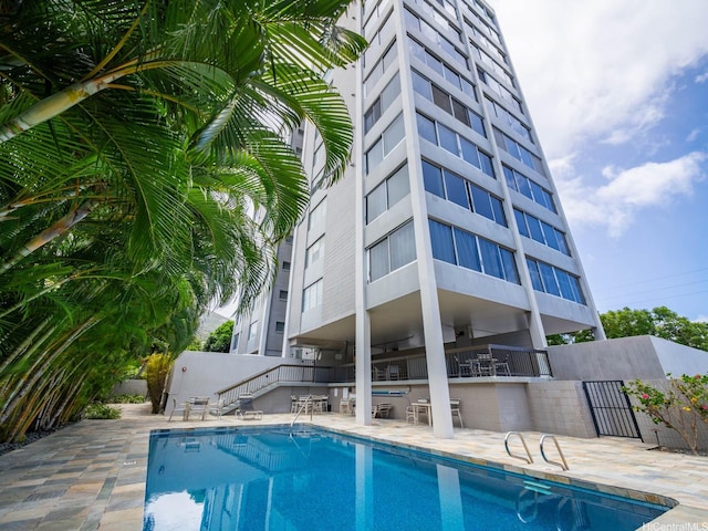 1545 Nehoa St Unit 402, Honolulu, HI 96822 - view of swimming pool featuring stairway and a patio area
