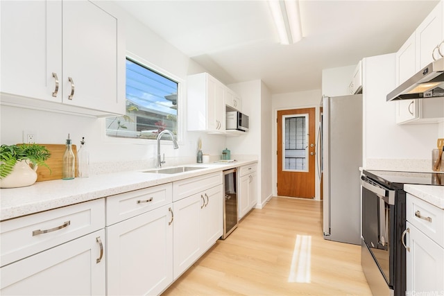 252 Anapalau St, Honolulu, HI 96825 - kitchen featuring stainless steel appliances, a sink, light wood-type flooring, and white cabinetry