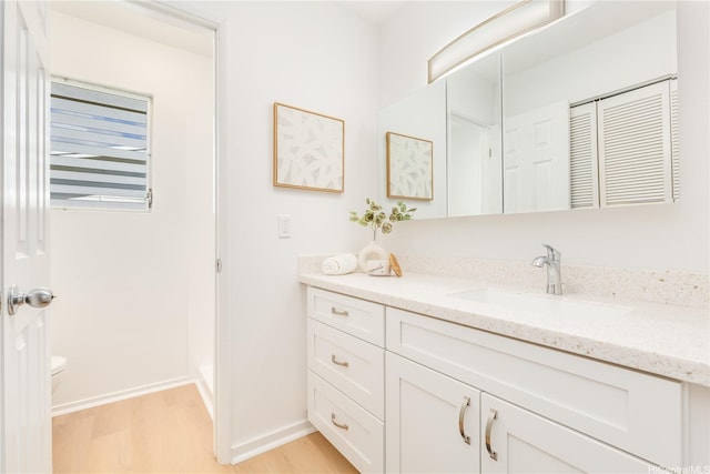 252 Anapalau St, Honolulu, HI 96825 - bathroom with vanity, wood finished floors, toilet, and baseboards