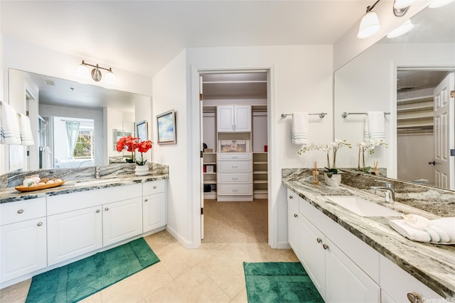 520 Lunalilo Home Rd Unit 7217, Honolulu, HI 96825 - bathroom featuring two vanities, a spacious closet, tile patterned floors, and baseboards