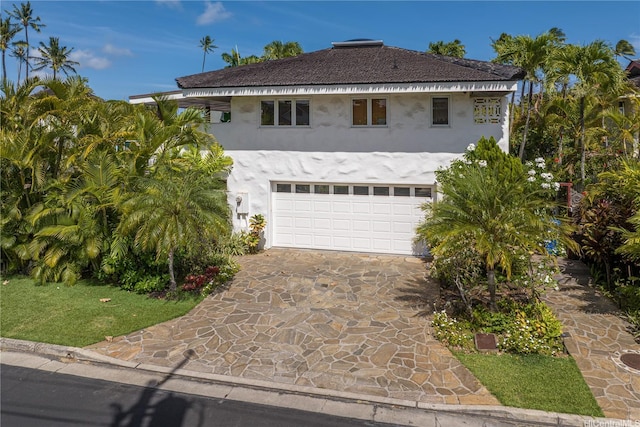 4745 Aukai Ave, Honolulu, HI 96816 - view of front of house with stucco siding, a garage, and driveway