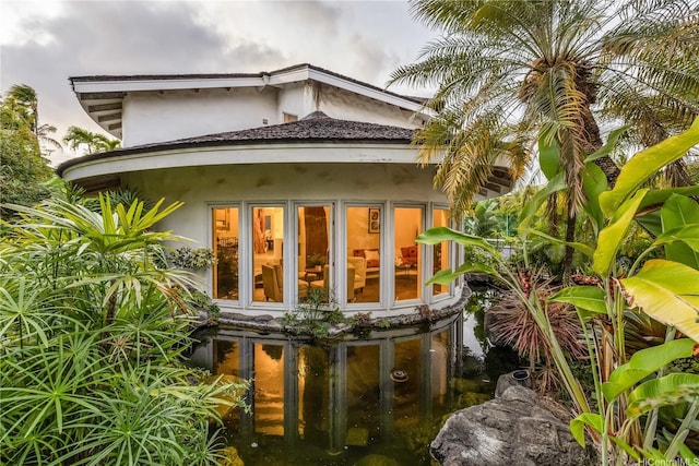 4745 Aukai Ave, Honolulu, HI 96816 - back of house with stucco siding and a garden pond