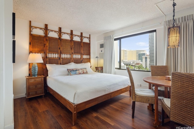 2140 Kuhio Ave Unit 1103, Nuc Honolulu, HI 96815 - bedroom featuring dark wood finished floors, a textured ceiling, and baseboards