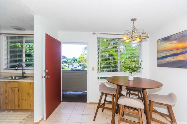 95-662 Hanile St Unit B201, Mililani, HI 96789 - dining space with a chandelier, a textured ceiling, and light tile patterned floors