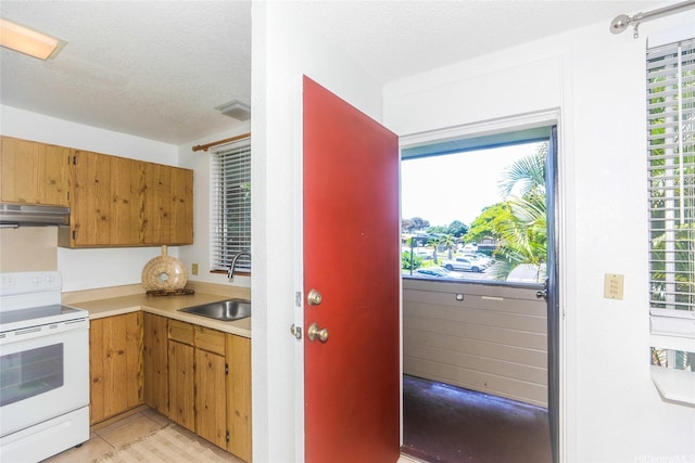 95-662 Hanile St Unit B201, Mililani, HI 96789 - kitchen featuring white range with electric cooktop, a sink, under cabinet range hood, light countertops, and a textured ceiling