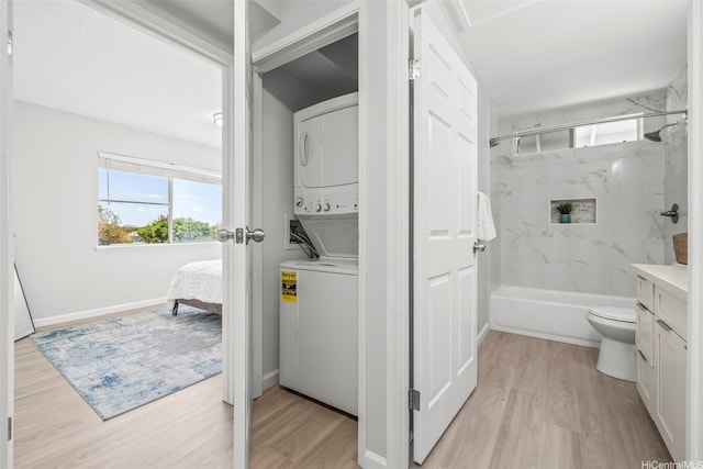 95-1015 Kaapeha St Unit 64, Mililani, HI 96789 - ensuite bathroom with estacked washer and dryer, wood finished floors, vanity, and toilet