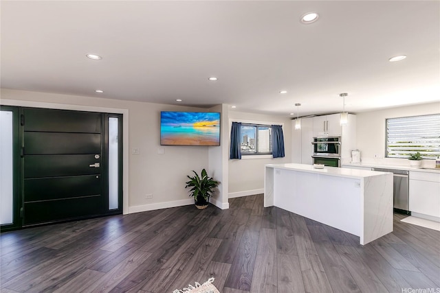 2638 Nakookoo St Unit 501, Honolulu, HI 96826 - kitchen with appliances with stainless steel finishes, a kitchen island, white cabinets, light countertops, and recessed lighting