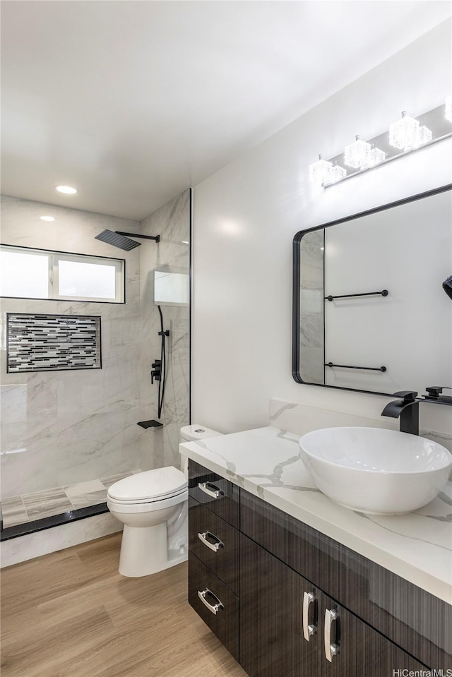 839 Oneawa St, Kailua, HI 96734 - full bathroom with toilet, vanity, tiled shower, and wood finished floors