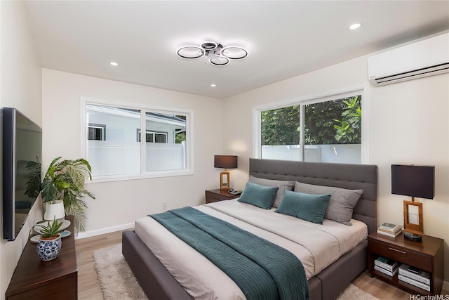 839 Oneawa St, Kailua, HI 96734 - bedroom featuring an AC wall unit, light wood finished floors, recessed lighting, and baseboards