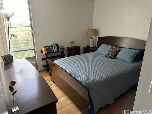 bedroom featuring light wood-style flooring