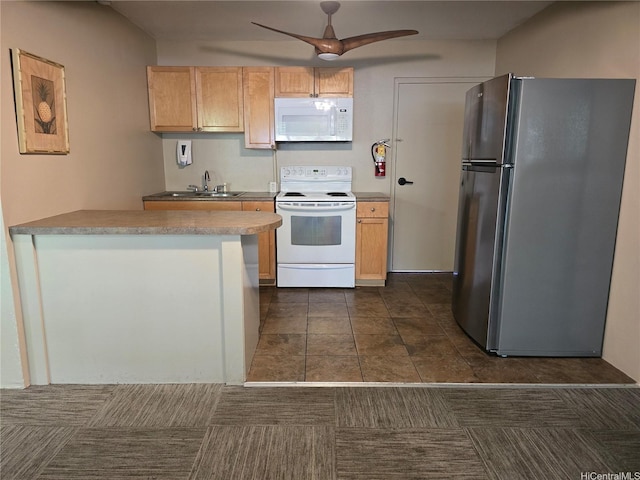 kitchen featuring white appliances, a ceiling fan, a sink, light countertops, and a peninsula