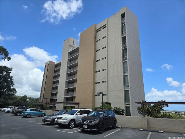 view of apartment building / complex featuring uncovered parking