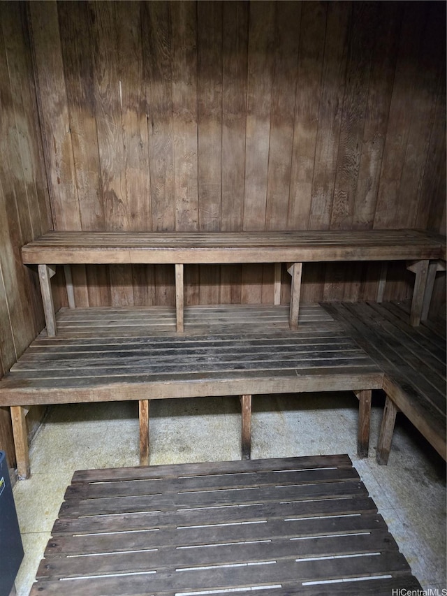 sauna featuring wood walls