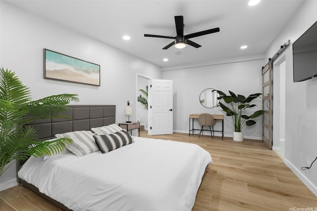 54-100 Kamehameha Hwy, Hauula, HI 96717 - bedroom featuring a barn door, recessed lighting, light wood-style flooring, a ceiling fan, and baseboards