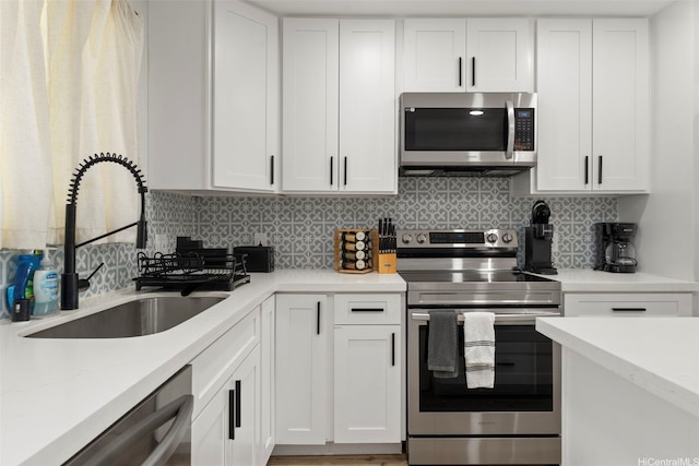54-100 Kamehameha Hwy, Hauula, HI 96717 - kitchen with stainless steel appliances, a sink, white cabinetry, and backsplash