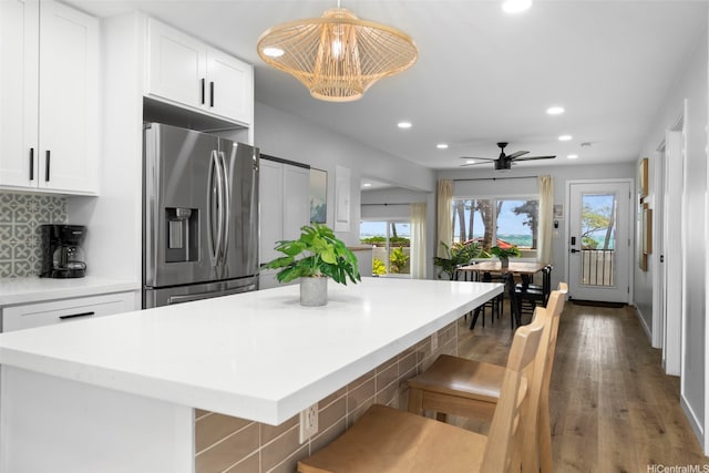 54-100 Kamehameha Hwy, Hauula, HI 96717 - kitchen with stainless steel refrigerator with ice dispenser, recessed lighting, white cabinetry, backsplash, and light countertops
