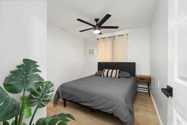 54-100 Kamehameha Hwy, Hauula, HI 96717 - bedroom with light wood-type flooring, an AC wall unit, a ceiling fan, and baseboards
