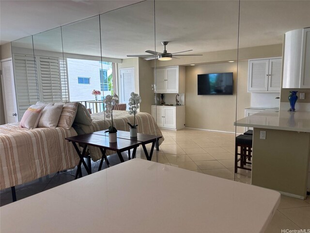 2987KALAKAUAAVENUE703 Kalakaua Ave Unit 703, Honolulu, HI 96850 - living area featuring baseboards, light tile patterned flooring, and ceiling fan
