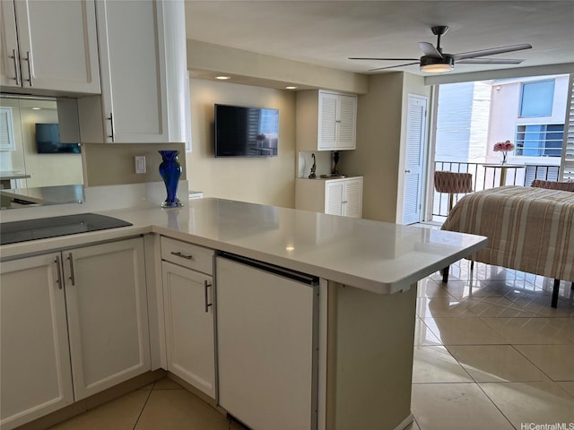 2987KALAKAUAAVENUE703 Kalakaua Ave Unit 703, Honolulu, HI 96850 - kitchen featuring light tile patterned floors, ceiling fan, a peninsula, light countertops, and refrigerator
