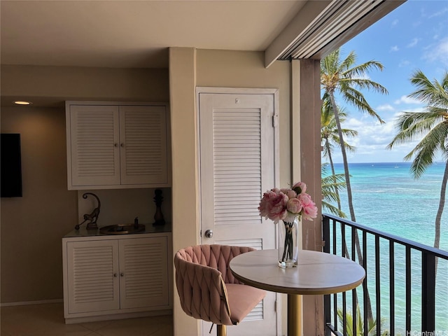 2987KALAKAUAAVENUE703 Kalakaua Ave Unit 703, Honolulu, HI 96850 - dining space featuring light tile patterned flooring, a water view, and baseboards