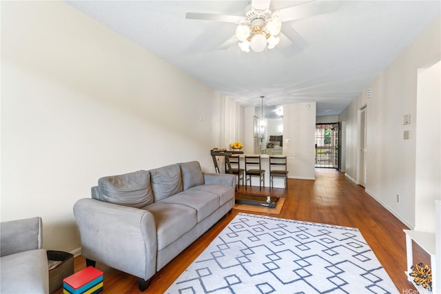 98-597 Kilinoe St Unit 10A1, Aiea, HI 96701 - living area featuring wood finished floors, a ceiling fan, and baseboards