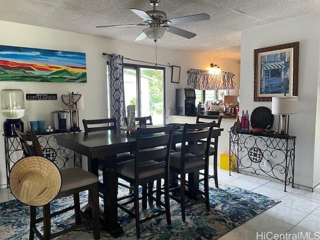 47-166 Wailehua Rd, Kaneohe, HI 96744 - dining room featuring a ceiling fan, light tile patterned floors, and a textured ceiling