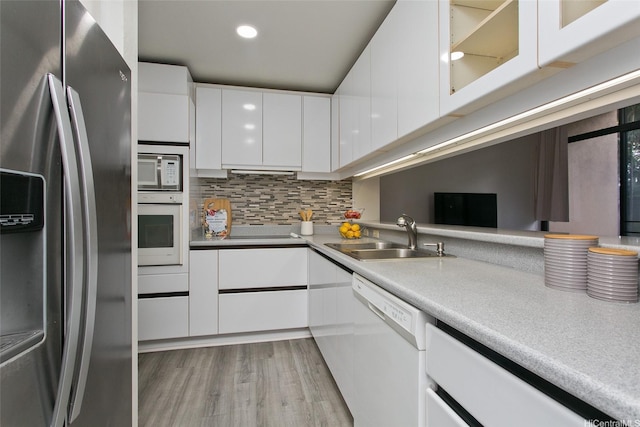 5333 Likini St Unit 110, Honolulu, HI 96818 - kitchen with white appliances, a sink, white cabinetry, modern cabinets, and recessed lighting