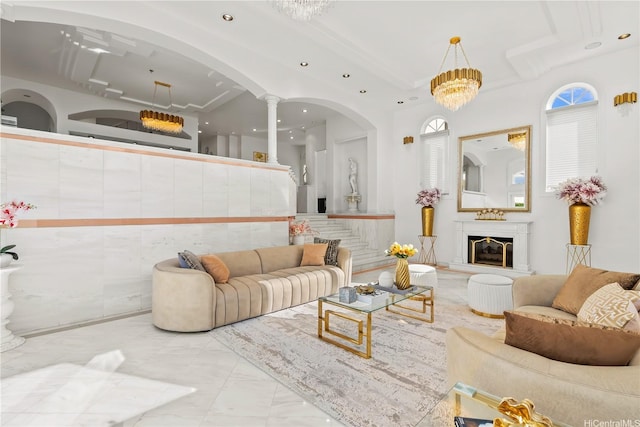 671 Kahiau Loop, Honolulu, HI 96821 - living room with recessed lighting, marble finish flooring, arched walkways, a high ceiling, and a glass covered fireplace
