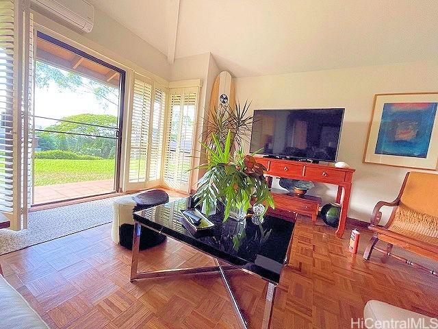 389 Kaelepulu Dr Unit 1501, Kailua, HI 96734 - living room featuring vaulted ceiling and a wall unit AC