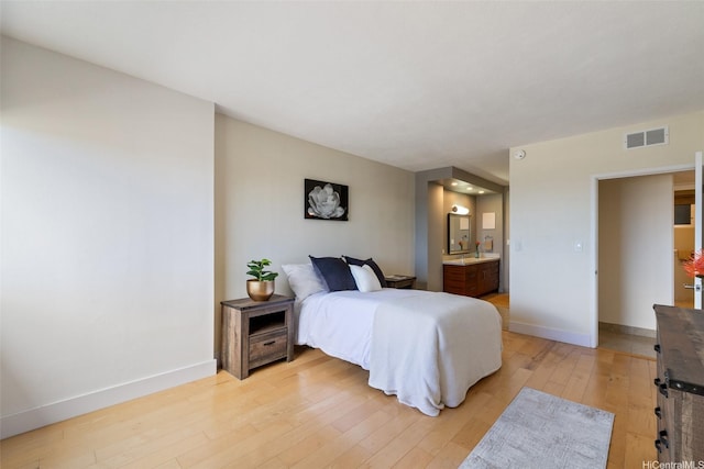 999 Wilder Ave Unit 1603, Honolulu, HI 96822 - bedroom with light wood-type flooring, baseboards, and ensuite bath