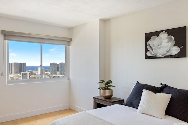999 Wilder Ave Unit 1603, Honolulu, HI 96822 - bedroom with wood finished floors and a city view