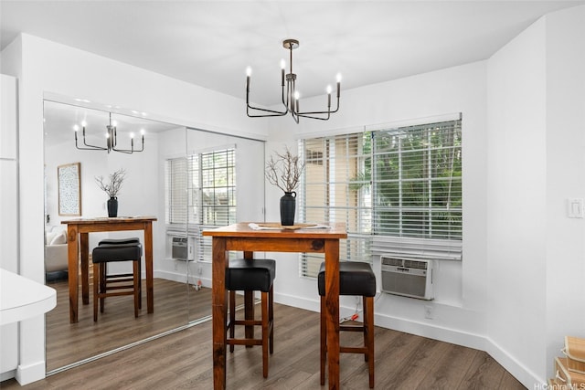306 Mananai Pl Unit 4D, Honolulu, HI 96818 - dining room featuring a chandelier, wood finished floors, cooling unit, and baseboards