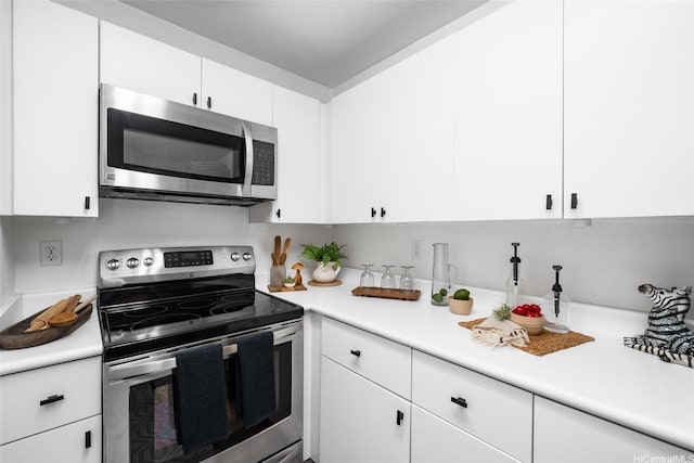 306 Mananai Pl Unit 4D, Honolulu, HI 96818 - kitchen with stainless steel appliances, light countertops, and white cabinets