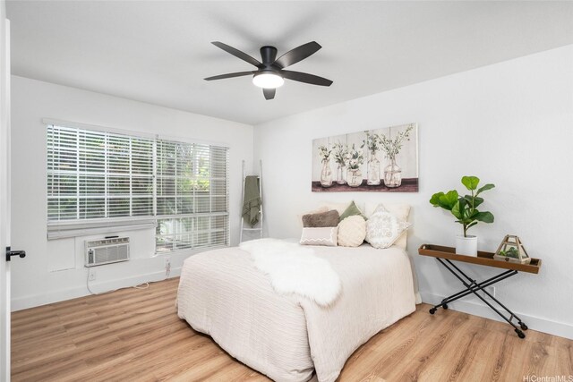 306 Mananai Pl Unit 4D, Honolulu, HI 96818 - bedroom with wood finished floors, an AC wall unit, a ceiling fan, and baseboards