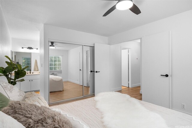 306 Mananai Pl Unit 4D, Honolulu, HI 96818 - bedroom with light wood-style floors, ceiling fan, and a closet