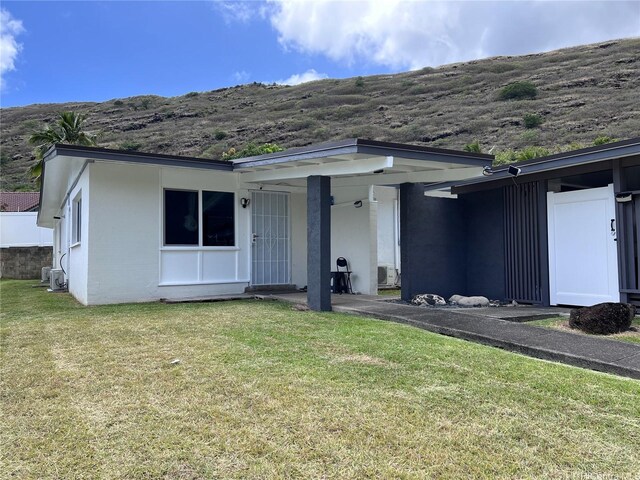 612 Ainapo St, Honolulu, HI 96825 - back of property featuring a yard and a mountain view