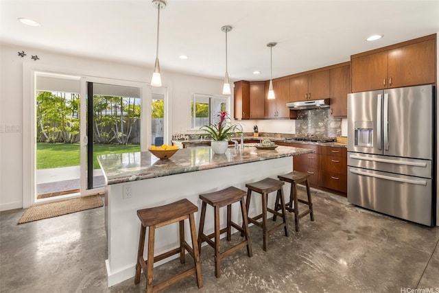440 Akoakoa Pl, Kailua, HI 96734 - kitchen featuring stainless steel appliances, under cabinet range hood, decorative backsplash, brown cabinets, and recessed lighting