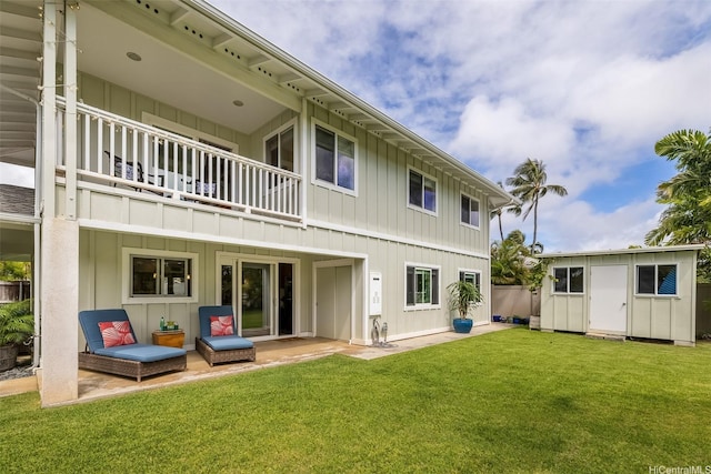 440 Akoakoa Pl, Kailua, HI 96734 - back of house with board and batten siding, a balcony, a yard, and a patio