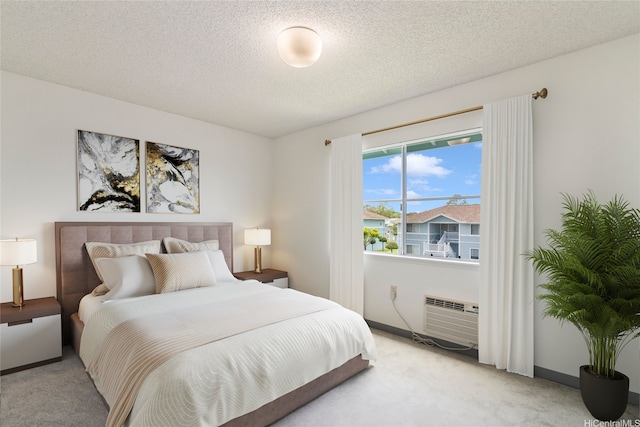 95-1180 Makaikai St Unit 74, Mililani, HI 96789 - bedroom featuring light carpet, a wall unit AC, a textured ceiling, and baseboards