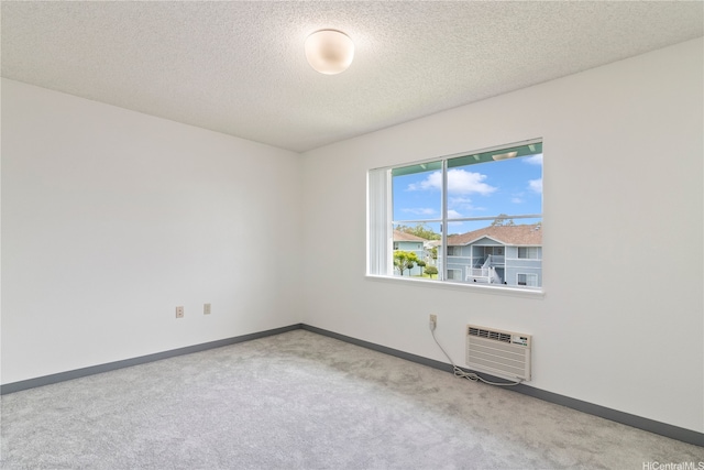 95-1180 Makaikai St Unit 74, Mililani, HI 96789 - unfurnished room featuring a wall mounted AC, carpet, baseboards, and a textured ceiling