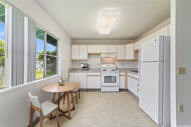 95-1180 Makaikai St Unit 74, Mililani, HI 96789 - kitchen with white appliances, under cabinet range hood, light countertops, a textured ceiling, and white cabinets