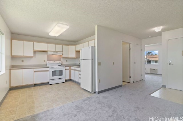 95-1180 Makaikai St Unit 74, Mililani, HI 96789 - kitchen with white appliances, under cabinet range hood, light countertops, a textured ceiling, and light carpet