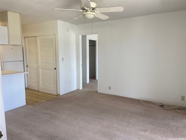 94-1081 Kepakepa St Unit K11, Waipahu, HI 96797 - unfurnished room with light carpet, a ceiling fan, and a textured ceiling