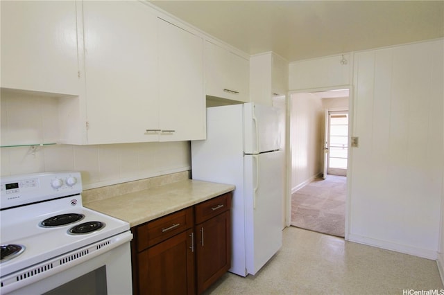 2459 Kapiolani Blvd, Honolulu, HI 96826 - kitchen with white appliances, light countertops, decorative backsplash, baseboards, and white cabinets