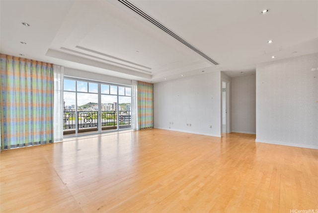 1740 S Beretania St Unit 10, Honolulu, HI 96826 - unfurnished room with a tray ceiling, light wood-style flooring, baseboards, and recessed lighting