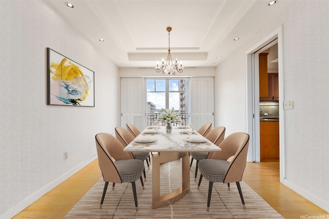 1740 S Beretania St Unit 10, Honolulu, HI 96826 - dining area with a chandelier, light wood-style flooring, a tray ceiling, baseboards, and recessed lighting
