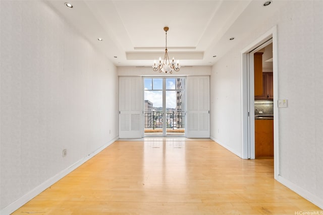 1740 S Beretania St Unit 10, Honolulu, HI 96826 - unfurnished dining area with a chandelier, a tray ceiling, light wood-type flooring, baseboards, and recessed lighting