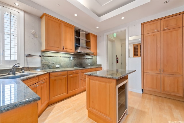 1740 S Beretania St Unit 10, Honolulu, HI 96826 - kitchen featuring wall chimney exhaust hood, beverage cooler, open shelves, light wood-type flooring, and a sink