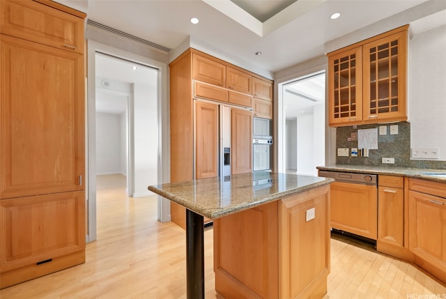 1740 S Beretania St Unit 10, Honolulu, HI 96826 - kitchen featuring decorative backsplash, a kitchen island, light wood-type flooring, light stone counters, and recessed lighting